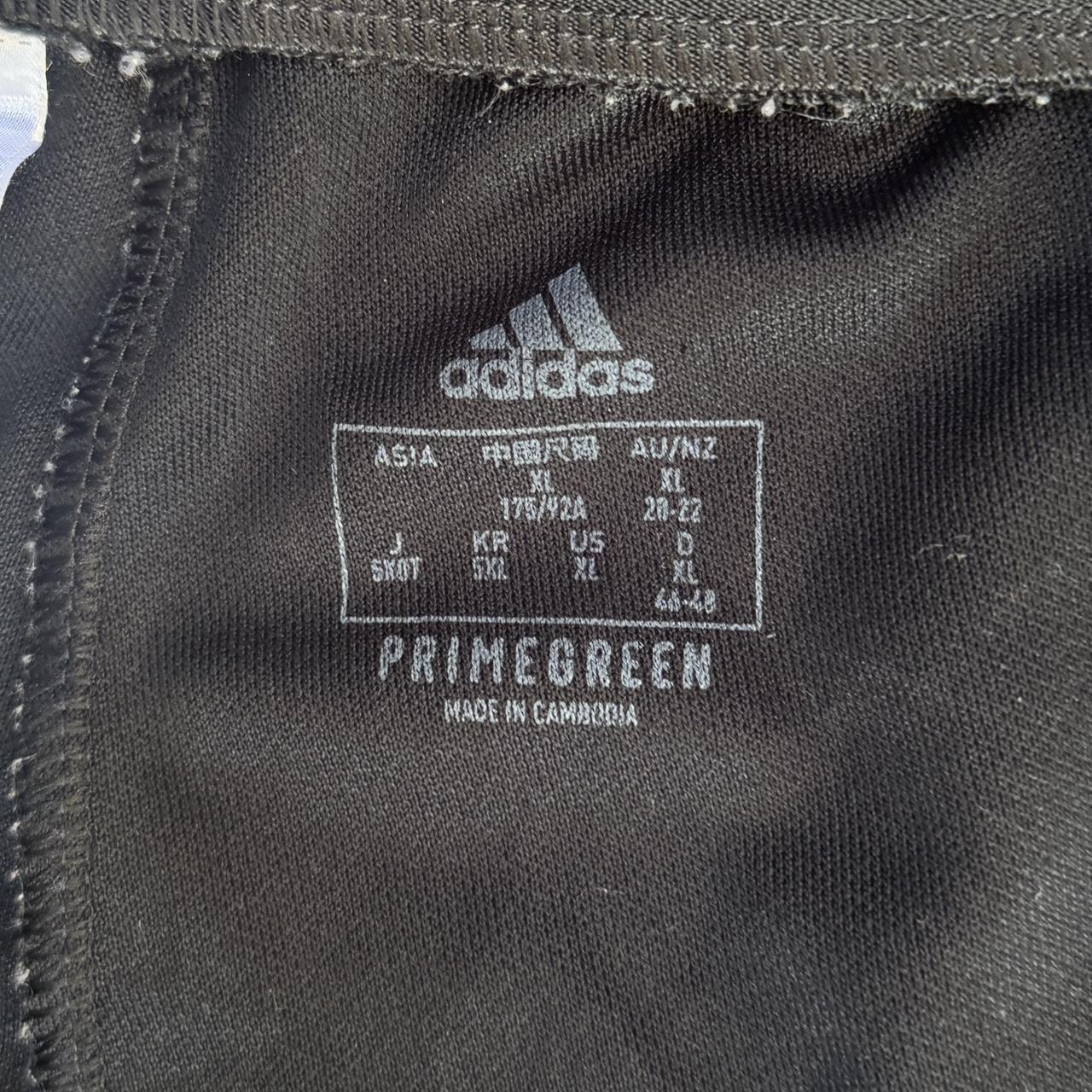 Black Adidas Primegreen joggers with white stripes