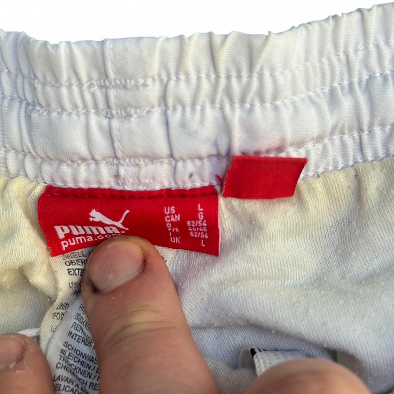 White Puma track pants with embroidered logo and drawstring waist