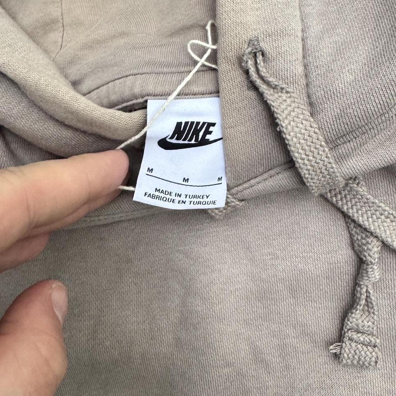 Light brown Nike hoodie with embroidered logo